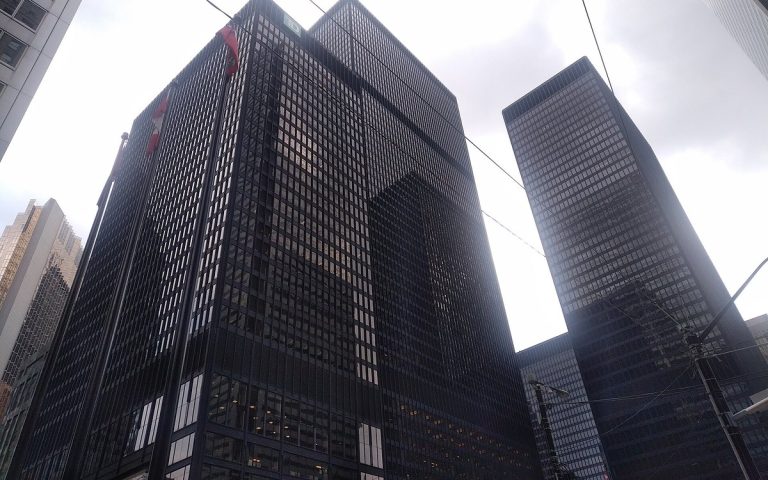 Dark glass office towers in a financial district seen from street level