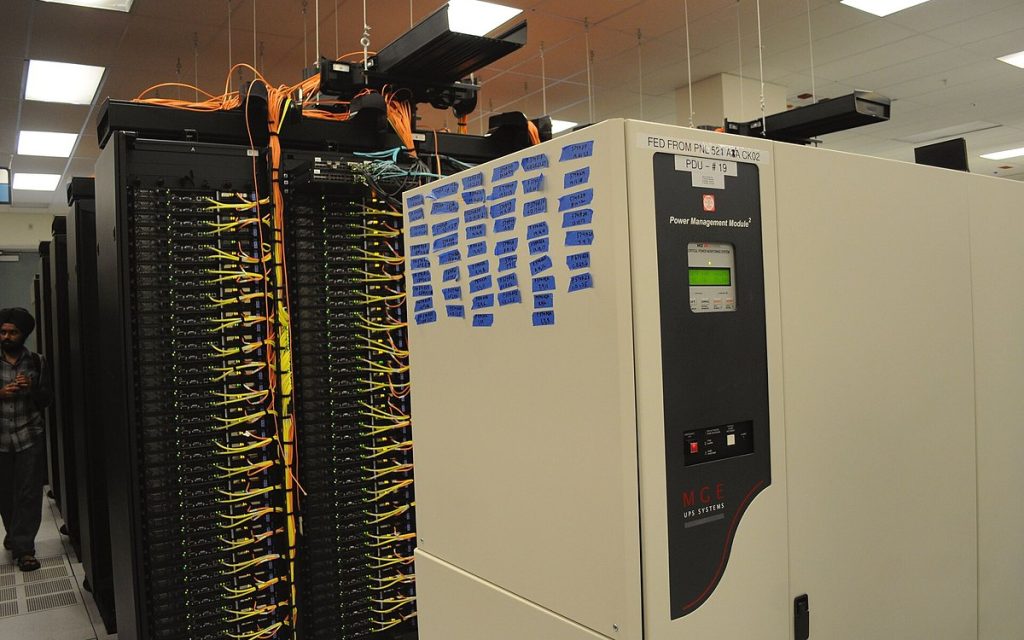 Rows of server racks and power units in a data center