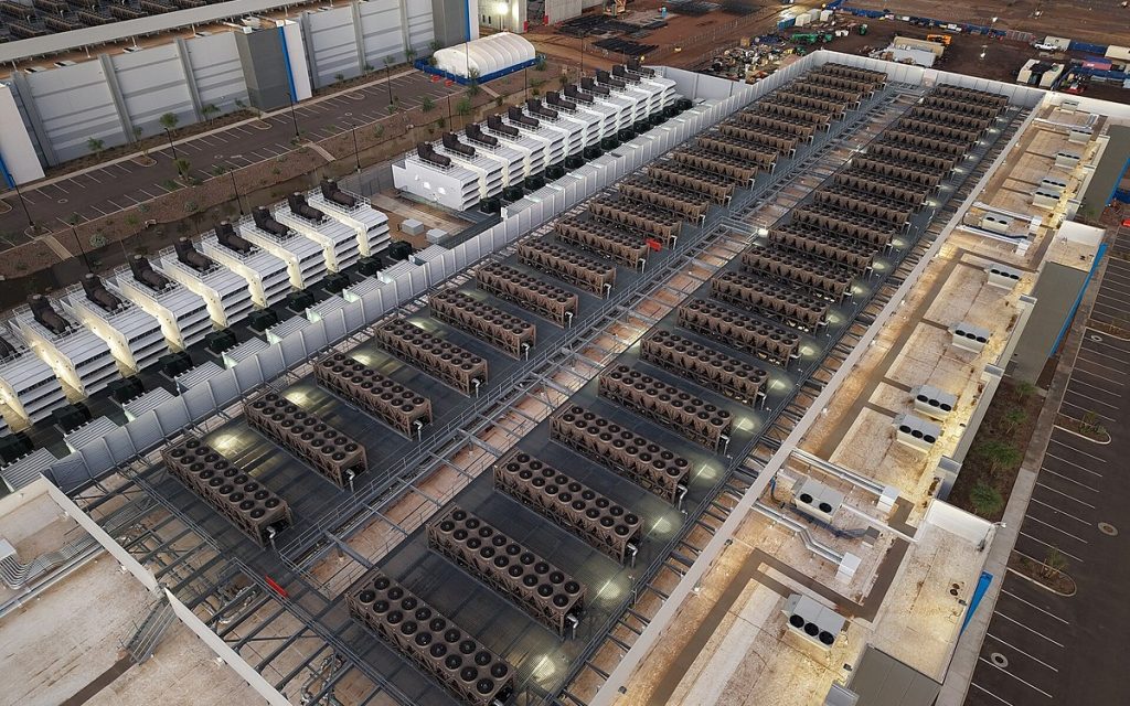 Aerial view of a data center roof lined with rows of cooling equipment